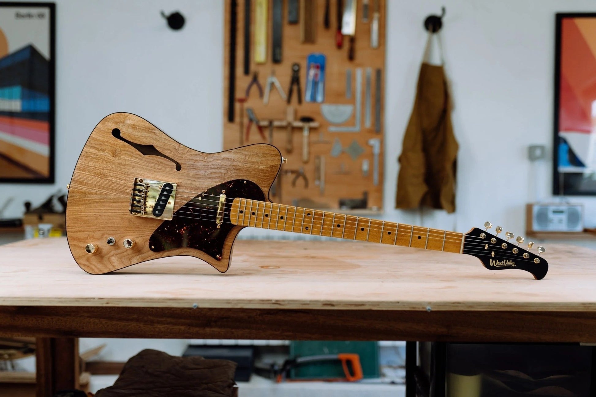 Indiana Slim electric guitar with elm top on workbench