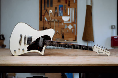 Indiana Classic electric guitar in Vintage White finish on workbench